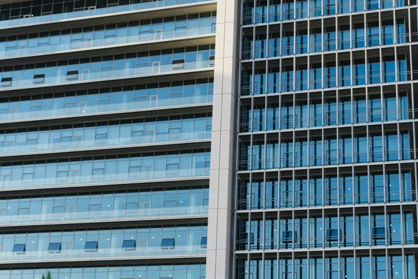 Modern high-rise office building with extensive glass windows and clean facade