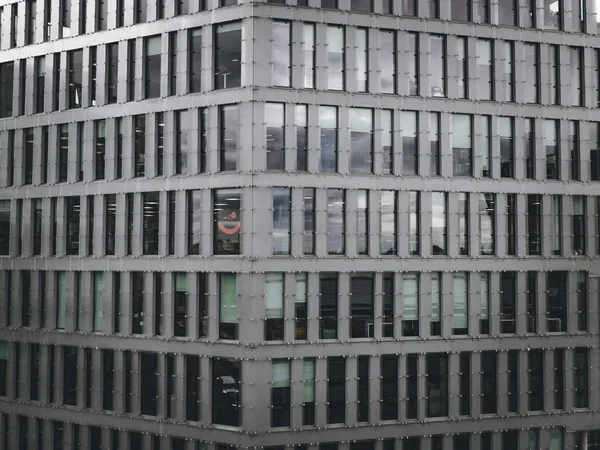 Modern glass curtain wall building with reflective windows and metal framing