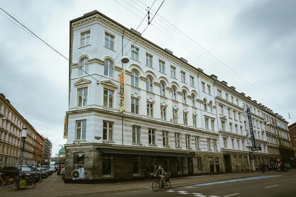 Historic multi-story building with classical arched windows and stone facade