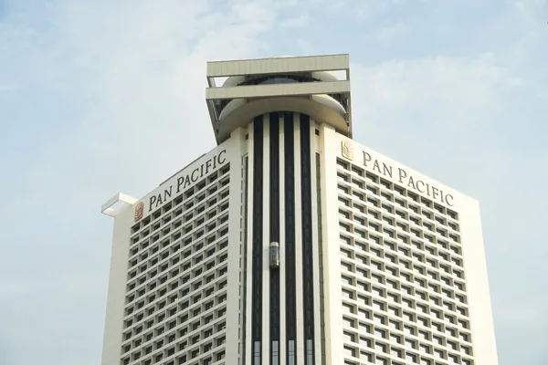 Tall hotel building with distinctive architectural tower and grid of windows