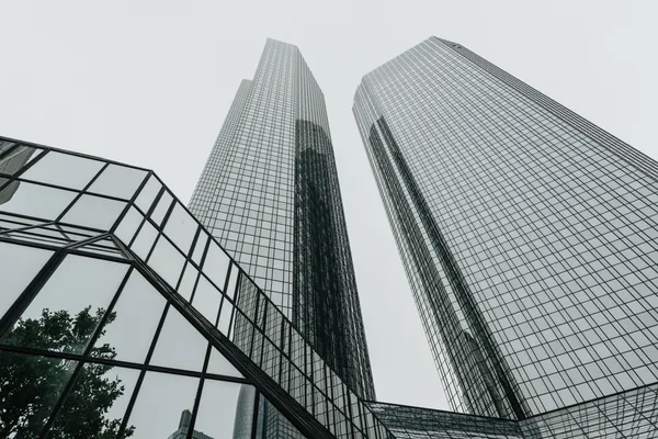 Modern glass skyscrapers with reflective windows and geometric architectural design