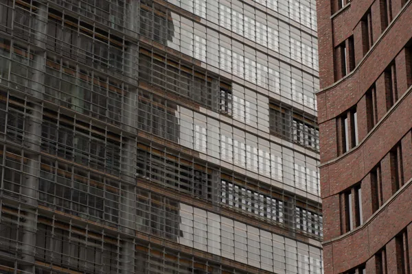 Modern building exterior with extensive glass windows and brick facade