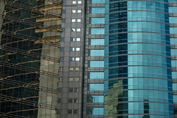 Modern skyscraper glass facades showing reflective windows and building exteriors